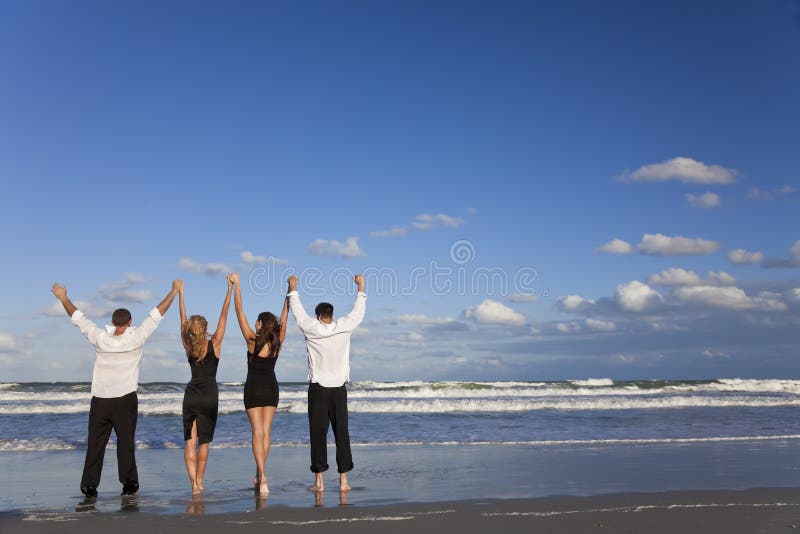 Two Couples, Arms Up Celebrating On Beach royalty free stock photos Two Couples, Arms Up Celebrating On Beach royalty free stock photos