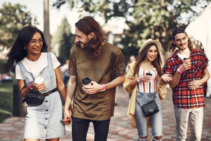 Two couples talking and enjoying pleasant walk royalty free stock photo Two couples talking and enjoying pleasant walk royalty free stock photo