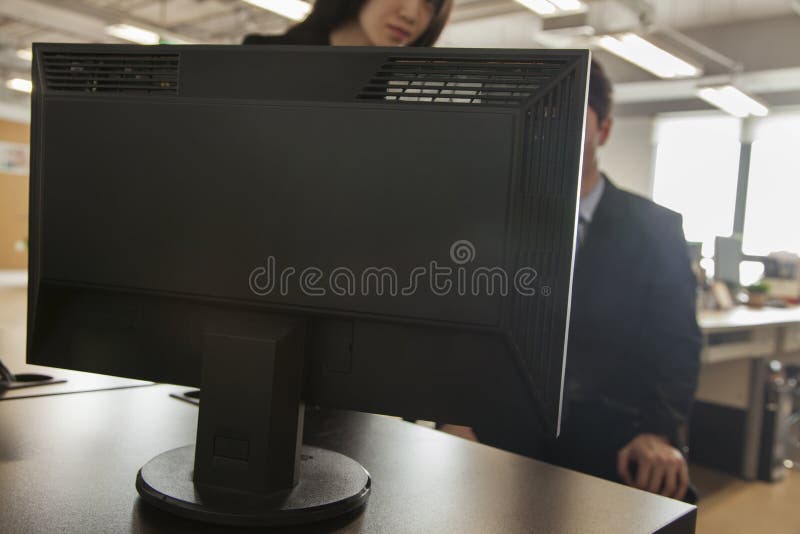 Two coworkers looking at computer monitor stock photos Two coworkers looking at computer monitor stock photos