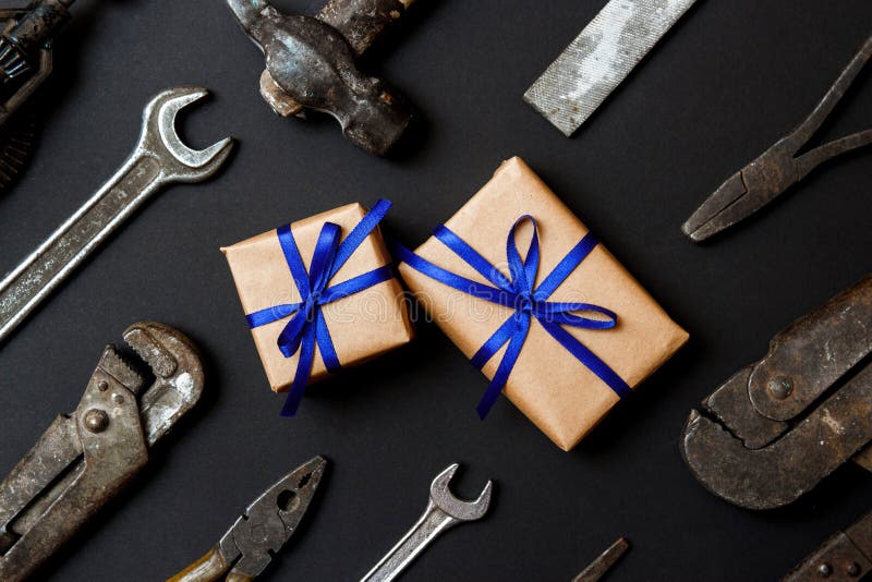 Two craft gifts with vintage old tools on black paper background. Fathers day concept. Flat lay royalty free stock photo Two craft gifts with vintage old tools on black paper background. Fathers day concept. Flat lay royalty free stock photo