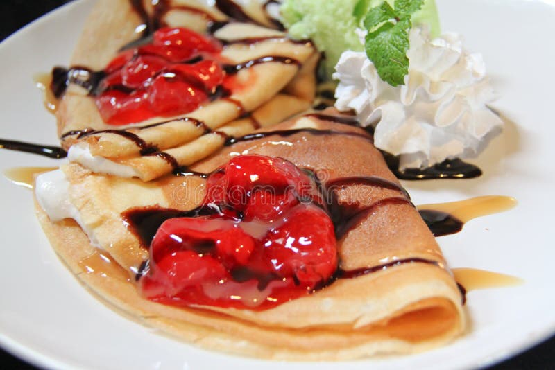 Two crepes with strawberries and Ice cream