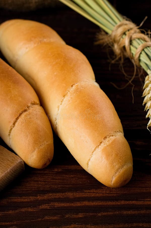 Two crispy rolls on wooden board