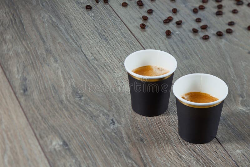 Two Cups of Espresso on a Wooden Background with Coffee Beans