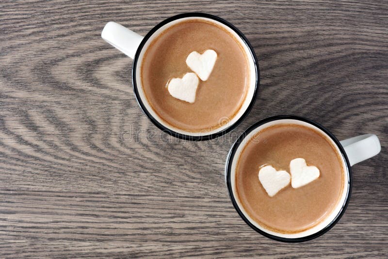 Hot chocolate with heart marshmallows over wood