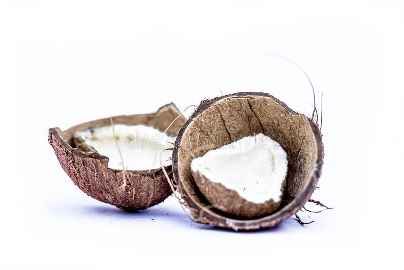Two Cut or Sliced Dried Coconuts Isolated on White with Dry Flash in it