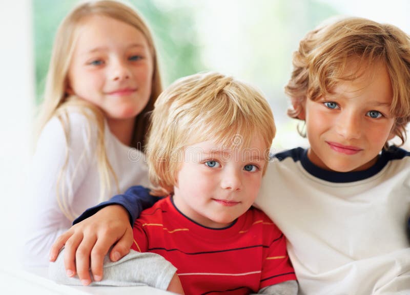 Two Cute Brothers And A Sister Sitting Together Portrait Of Two Cute