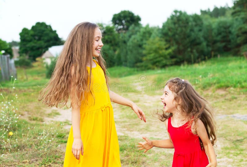 Two beautiful little girls playing and smiling at sunny summer d stock photography Two beautiful little girls playing and smiling at sunny summer d stock photography