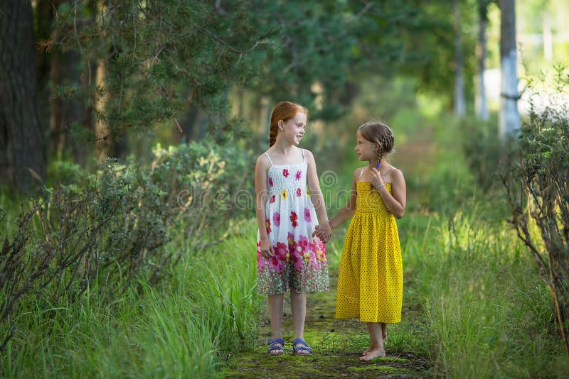 Two cute little girls talking in the Park. Walking.