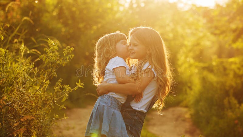 Two Sisters Family Time Kiss Stock Photos - Free & Royalty-Free Stock ...