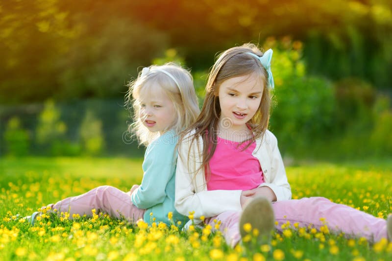 Two Cute Little Sisters Having Fun on the Grass Stock Photo - Image of ...