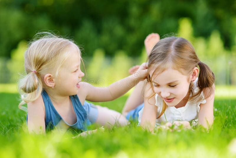 Two Cute Little Sisters Having Fun Together on the Grass on Summer Day ...