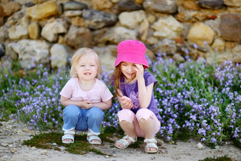 Two cute little sisters at summer royalty free stock image Two cute little sisters at summer royalty free stock image
