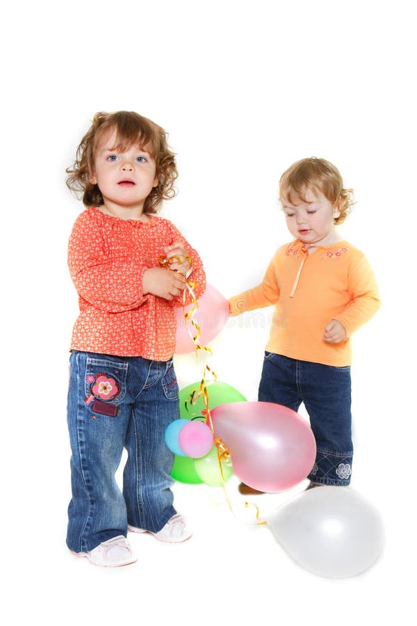 Two cute toddler girls with balloons