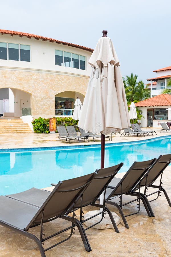 Chaise lounge by the pool stock image. Image of resort 236502841