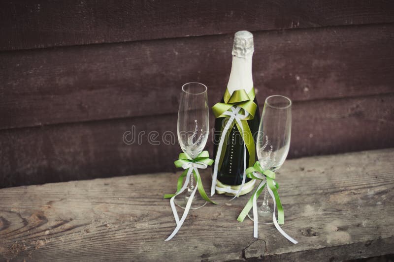 Two Decorated Bottles of Champagne and Brandy As Bride and Groom on