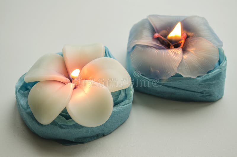 Two Decorative Burning Candles in the Shape of Flowers Stock Photo