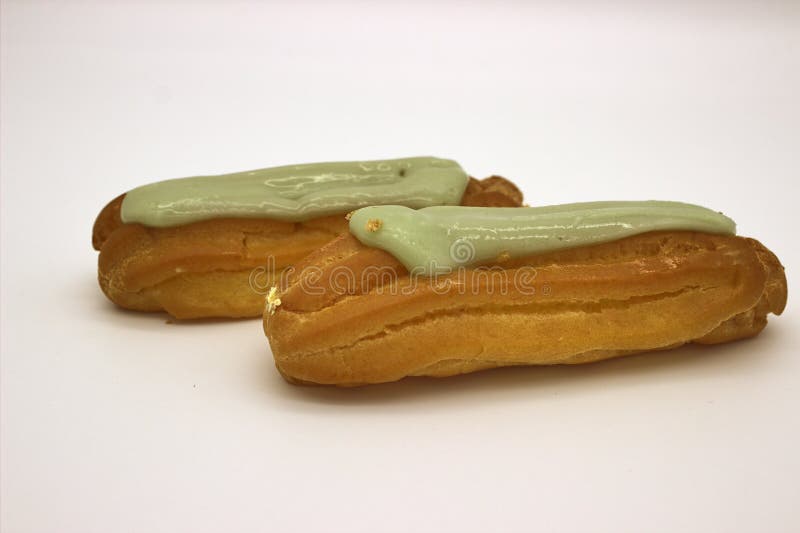 Two Delicious Pistachio Eclairs. An Isolated Image On White Background stock photo Two Delicious Pistachio Eclairs. An Isolated Image On White Background stock photo