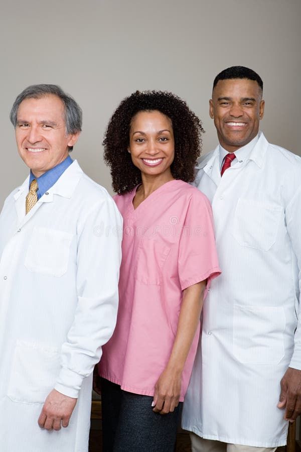 Two dentists and a dental nurse royalty free stock image