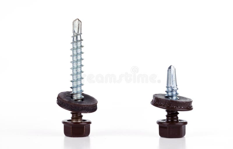 Two different length screws for fixing the roof with brown hex heads. Isolated on white royalty free stock images Two different length screws for fixing the roof with brown hex heads. Isolated on white royalty free stock images