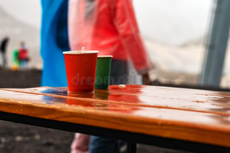 Two Disposable Cups of Different Sizes. with Leftover Coffee Stock