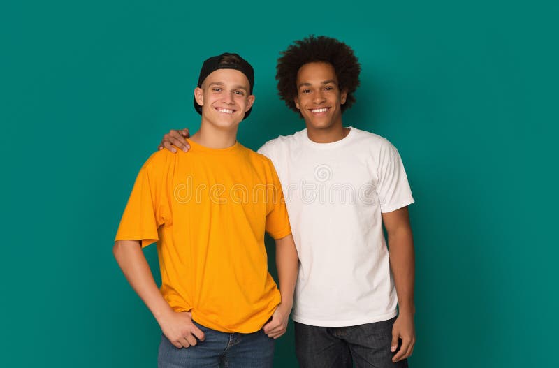 Two best friends hugging and looking at camera over background stock photo Two best friends hugging and looking at camera over background stock photo