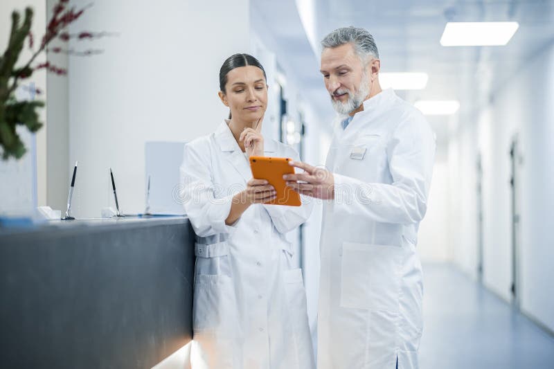 Two Doctors Talking in the Hospital during the Shift Change Stock Photo Image of work, doctors