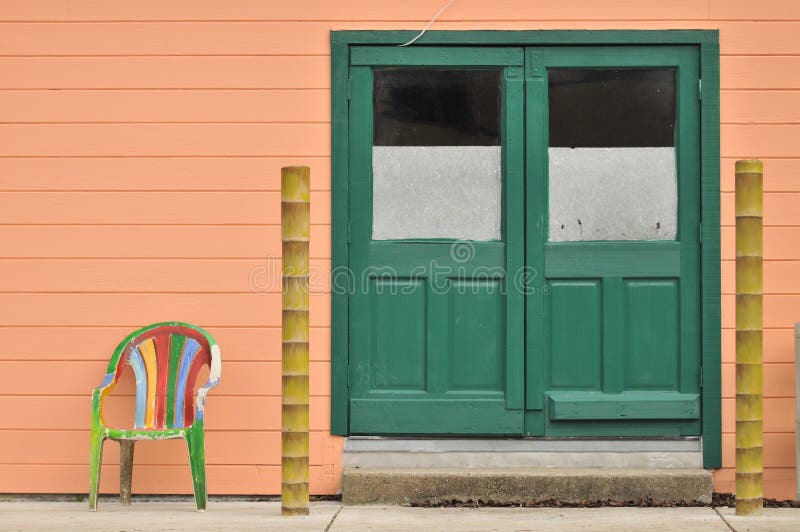 Two Doors with a Chair and Poles Stock Photo Image of wall, colorful