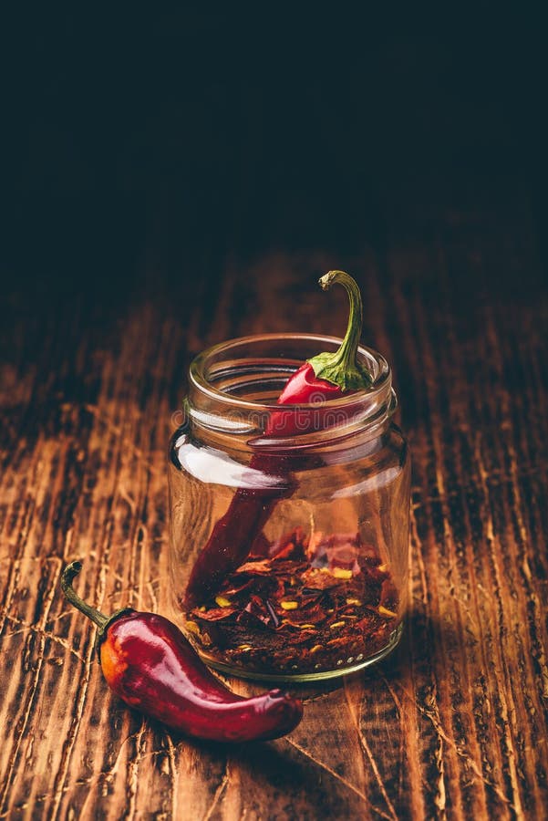 Two dried red chili peppers in jar stock photos Two dried red chili peppers in jar stock photos