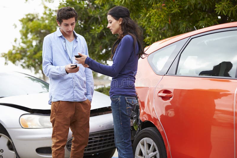 Two Drivers Exchange Insurance Details after Accident Stock Photo