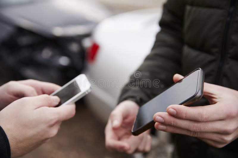 Two Drivers Exchanging Insurance Details After Car