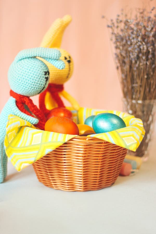 Two Easter Bunny Near the Basket with Colorful Painted Eggs. Stock