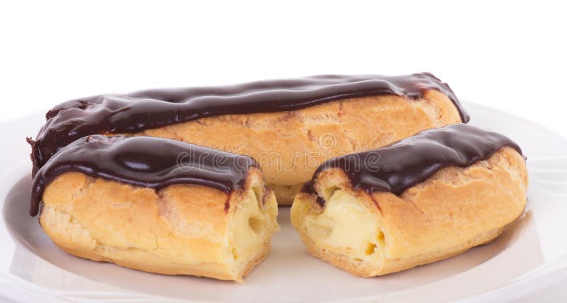 Two Eclairs on White Plate stock images