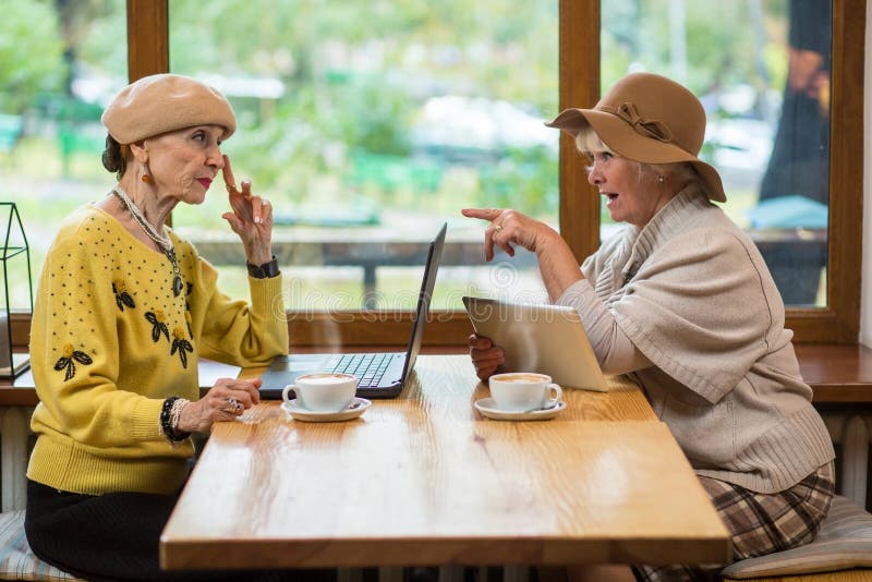 Two elderly women in cafe. stock image. Image of food 85032185