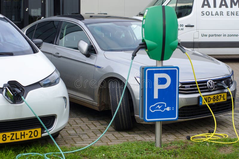 Two electric cars connected to charge station