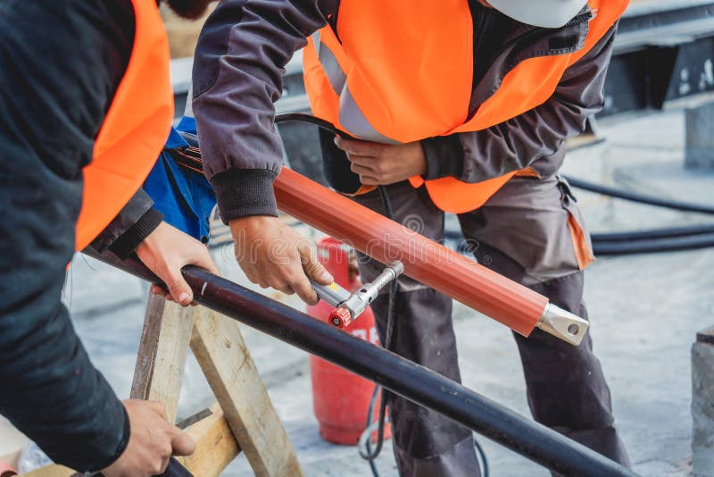 Two Electrician Builder Workers Installing Highvoltage Cable Stock
