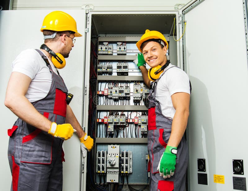 Two electricians on a factory royalty free stock image