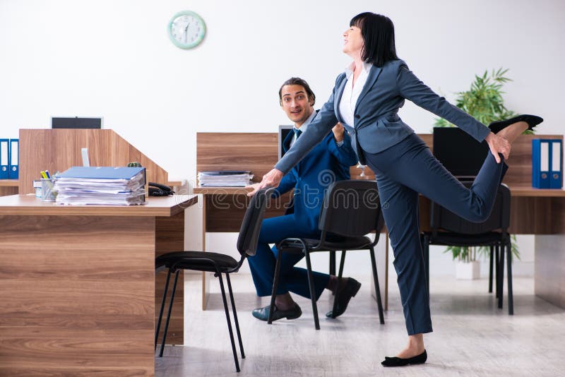 Two Employees Doing Sport Exercises in the Office Stock Photo Image