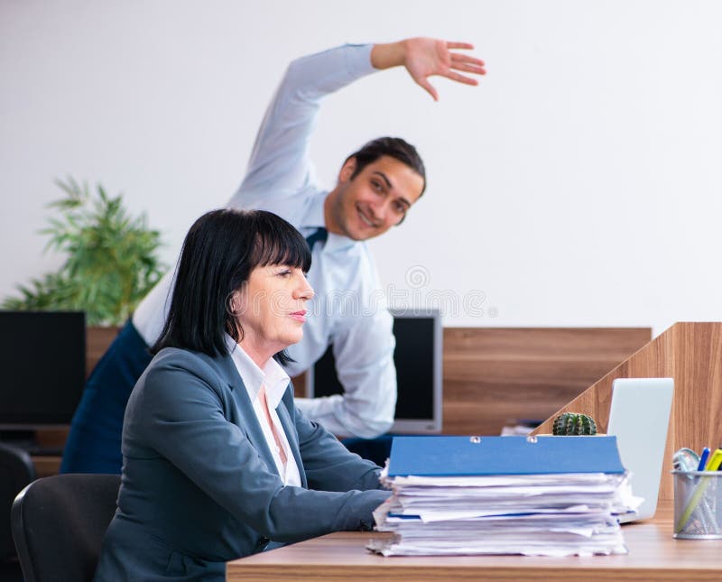 Two Employees Doing Sport Exercises in the Office Stock Photo Image