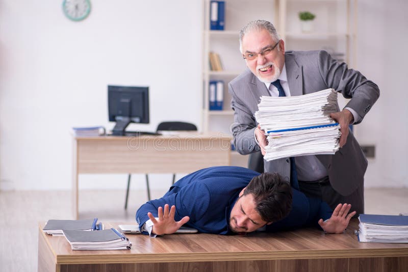 Two Male Employees and Too Much Work in the Office Stock Photo Image