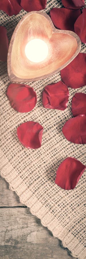 Two enlightened candles in heart-shaped candleholders with rose royalty free stock photography Two enlightened candles in heart-shaped candleholders with rose royalty free stock photography