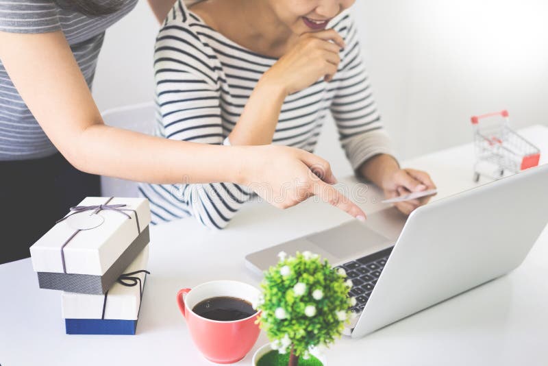 Two excited roommates friends shopping online with credit card a