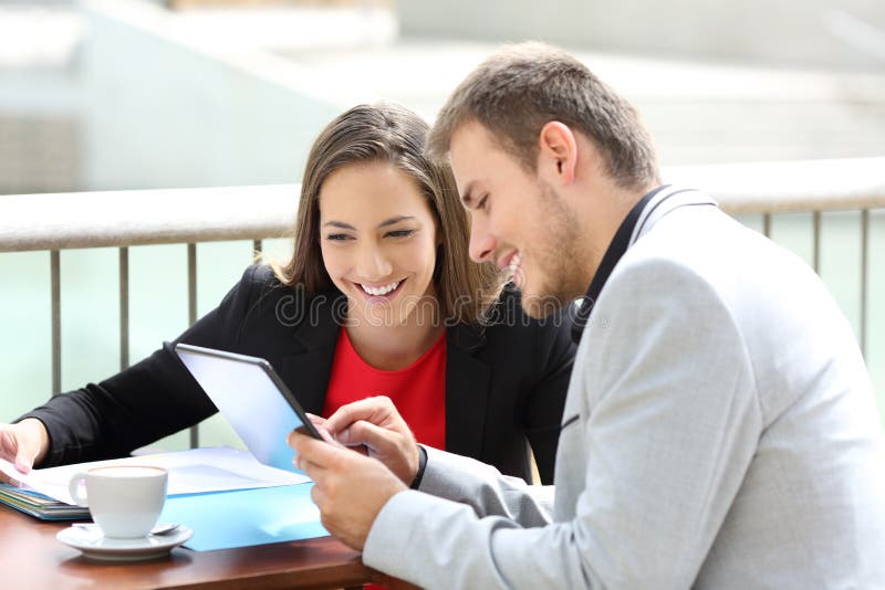 Two executives consulting on line data