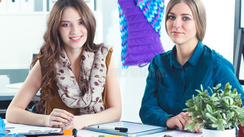 Two fashion designers working together at the desk stock photos Two fashion designers working together at the desk stock photos