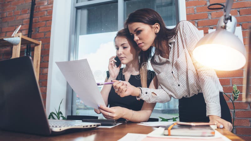 Two female colleagues in office working together. royalty free stock images