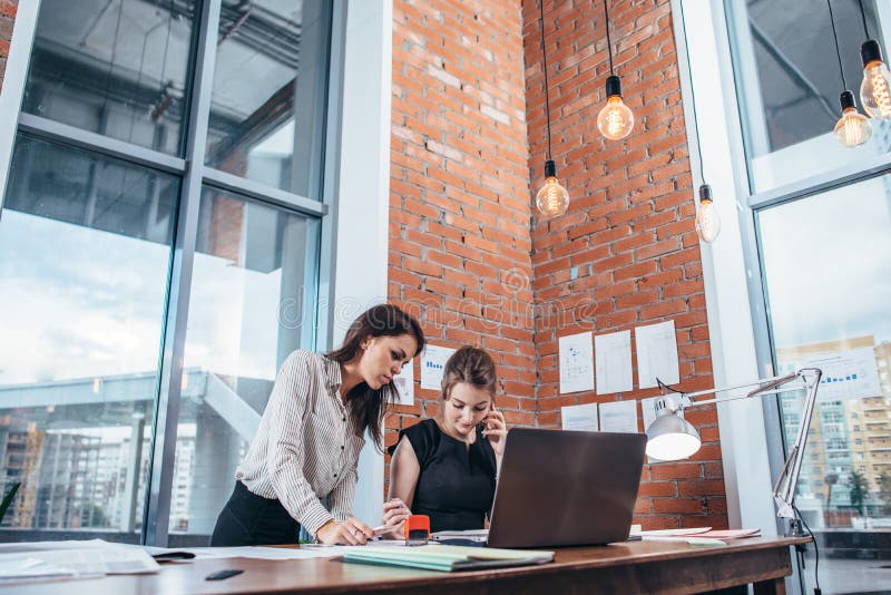 Two female colleagues in office working together. royalty free stock photography