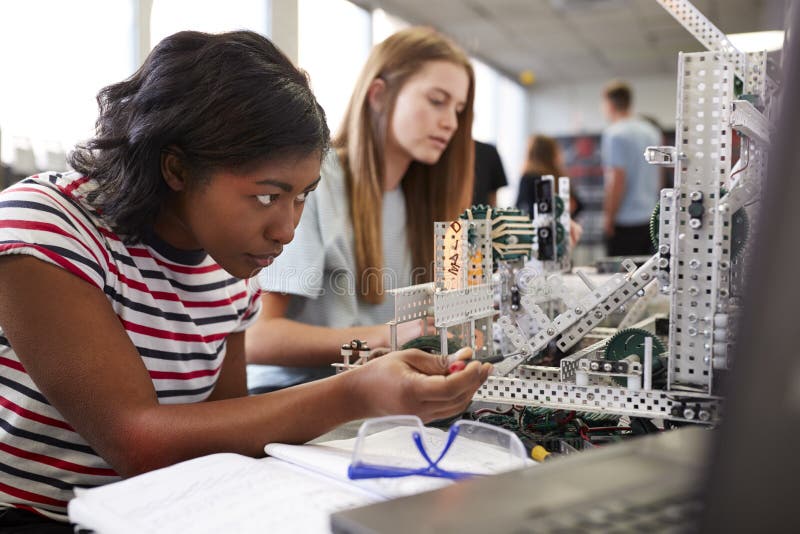 Two Female College Students Building Machine In Science Robotics Or Engineering Class stock photography