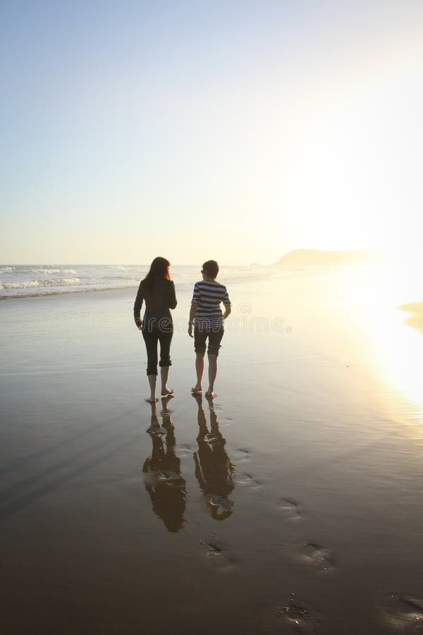 Silhouette figures on the beach stock image Silhouette figures on the beach stock image