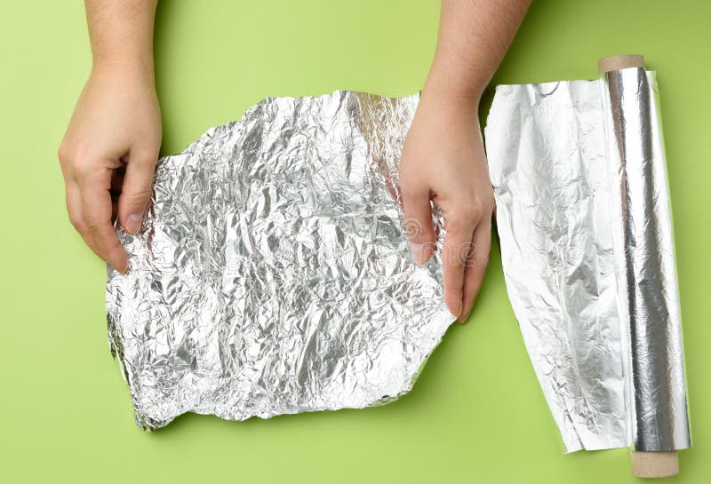 https://thumbs.dreamstime.com/b/two-female-hands-holds-crumpled-silver-foil-green-background-top-view-two-female-hands-holds-crumpled-silver-foil-green-202791797.jpg