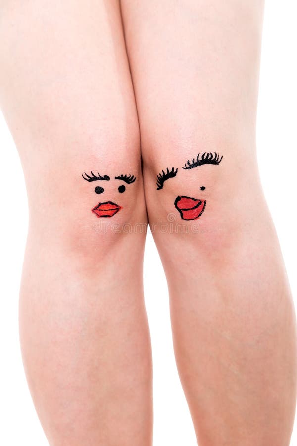 Two female knees with faces, isolated