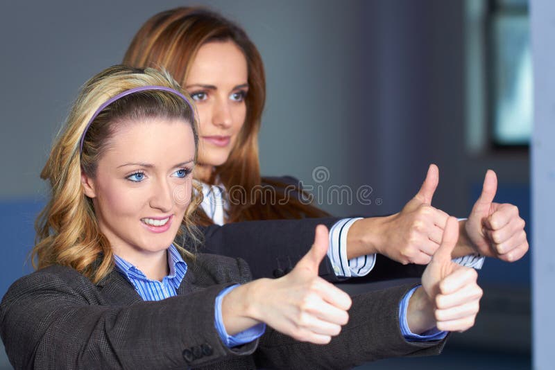 Two females shows thumb up gesture